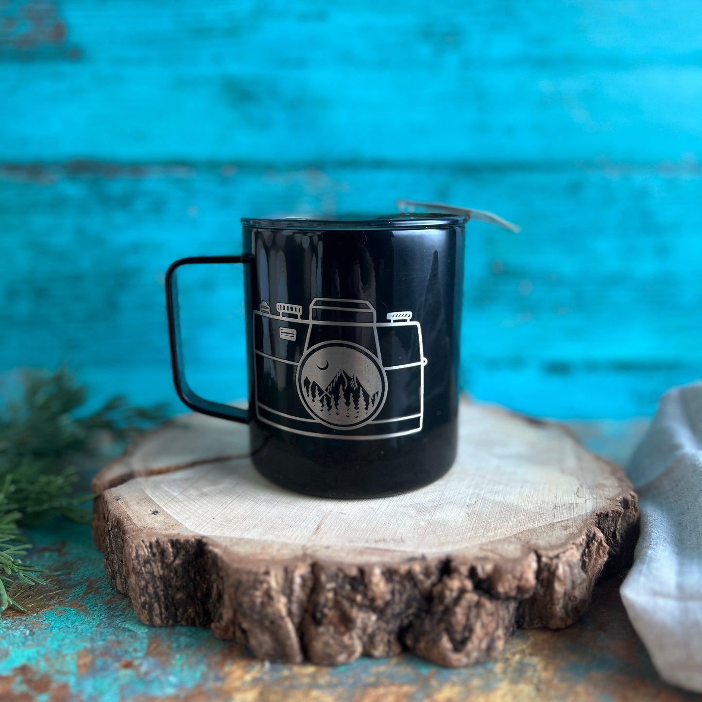 Camera with mountain scene coffee cup